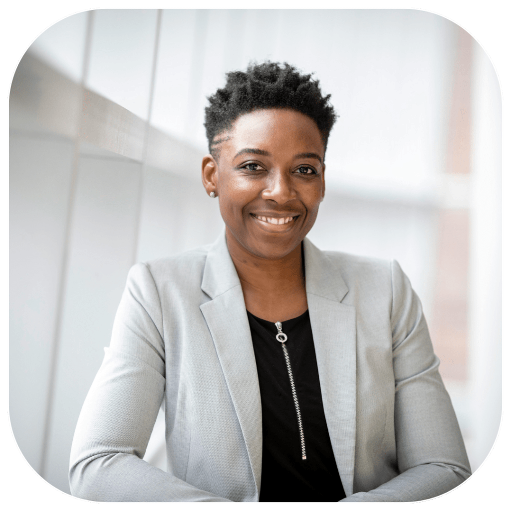 Black businesswomen smiling into the camera expressing confidence